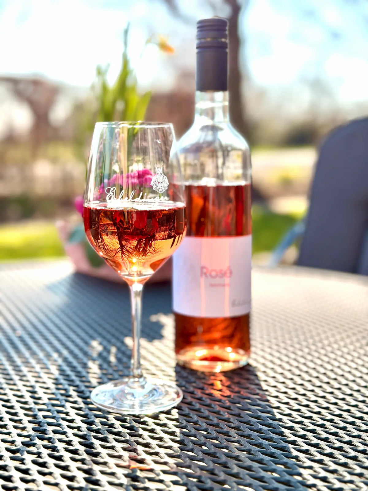 Rosé-Wein im Glas mit Flasche